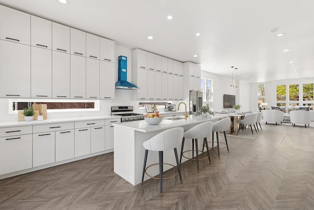1537 Scoville Ave, Berwyn, IL 60402 - kitchen featuring gas range oven, wall chimney exhaust hood, modern cabinets, stainless steel fridge, and open floor plan