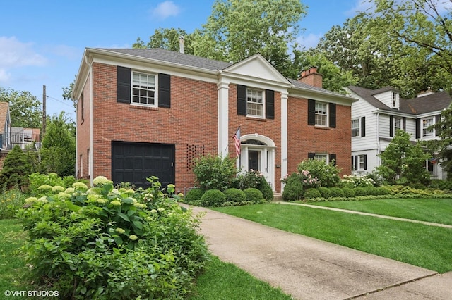 2735 Simpson St, Evanston, IL 60201 - neoclassical / greek revival house featuring a garage, brick siding, a chimney, and driveway