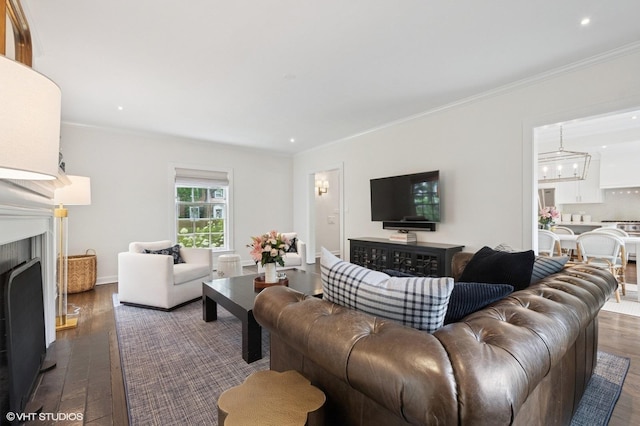 2735 Simpson St, Evanston, IL 60201 - living room with dark wood-type flooring, a fireplace, crown molding, recessed lighting, and a chandelier