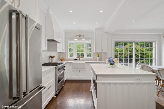 2735 Simpson St, Evanston, IL 60201 - kitchen with stainless steel appliances, ornamental molding, decorative backsplash, a center island, and light countertops