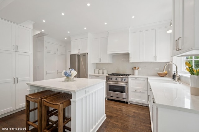 2735 Simpson St, Evanston, IL 60201 - kitchen featuring high end appliances, a center island, premium range hood, white cabinets, and recessed lighting
