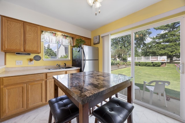 2N477 Bernice Ave, Glen Ellyn, IL 60137 - kitchen with freestanding refrigerator, light marble finish flooring, brown cabinetry, and light countertops