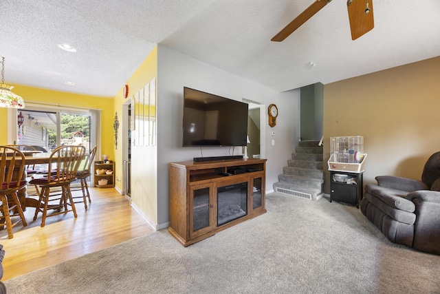 2N477 Bernice Ave, Glen Ellyn, IL 60137 - living room with carpet floors, a textured ceiling, a ceiling fan, stairway, and wood finished floors