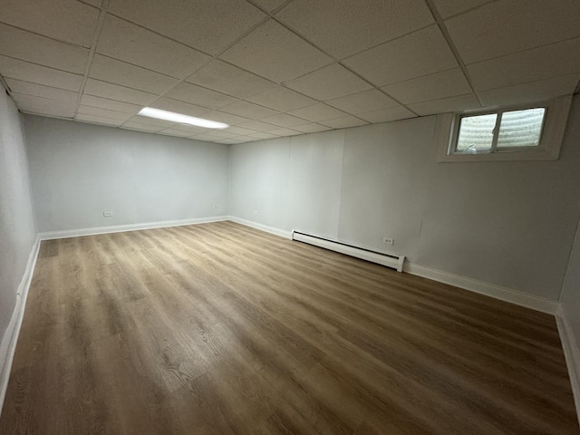 8852 Robin Dr Unit E, Des Plaines, IL 60016 - below grade area featuring a baseboard radiator, wood finished floors, and a drop ceiling