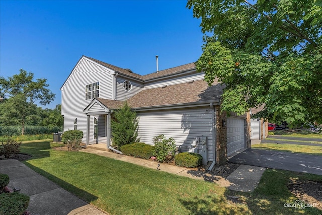 61 King Dr, Streamwood, IL 60107 - traditional home with a front lawn, a shingled roof, driveway, and a garage