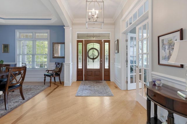 700 E Sunnyside Ave, Libertyville, IL 60048 - foyer with a decorative wall, a chandelier, light wood-style flooring, a wainscoted wall, and crown molding
