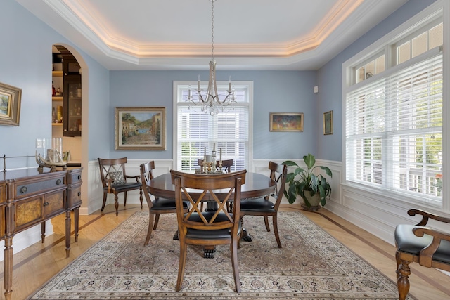 700 E Sunnyside Ave, Libertyville, IL 60048 - dining space featuring a raised ceiling, a chandelier, a wainscoted wall, ornamental molding, and arched walkways