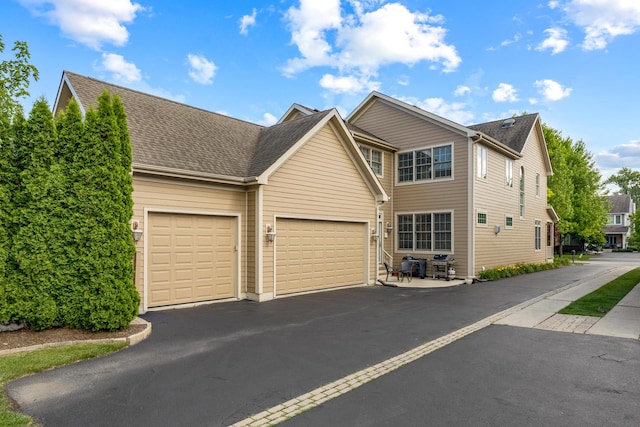 700 E Sunnyside Ave, Libertyville, IL 60048 - traditional home featuring a garage, driveway, and roof with shingles