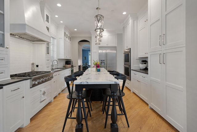 700 E Sunnyside Ave, Libertyville, IL 60048 - kitchen with premium range hood, stainless steel appliances, white cabinetry, recessed lighting, and decorative backsplash