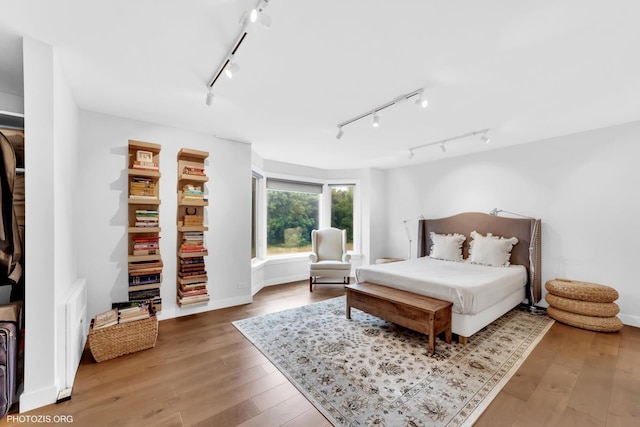 300 Thames Pkwy Unit 2A, Park Ridge, IL 60068 - bedroom featuring rail lighting and wood-type flooring