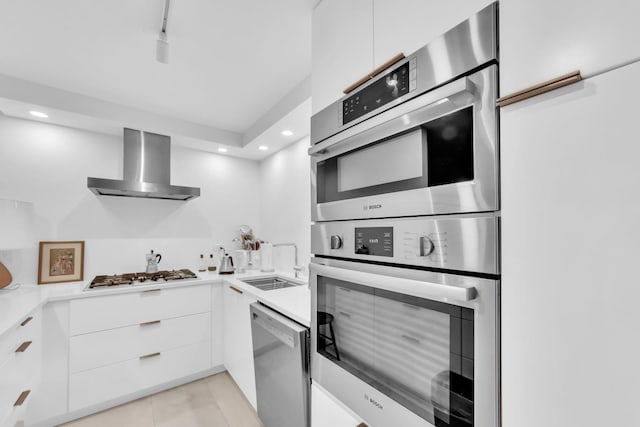 300 Thames Pkwy Unit 2A, Park Ridge, IL 60068 - kitchen featuring wall chimney range hood, modern cabinets, appliances with stainless steel finishes, white cabinetry, and light countertops