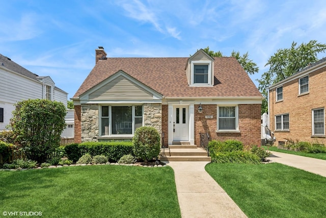 530 S Vail Ave, Arlington Heights, IL 60005 - cape cod house with a front yard, a chimney, a shingled roof, and stone siding