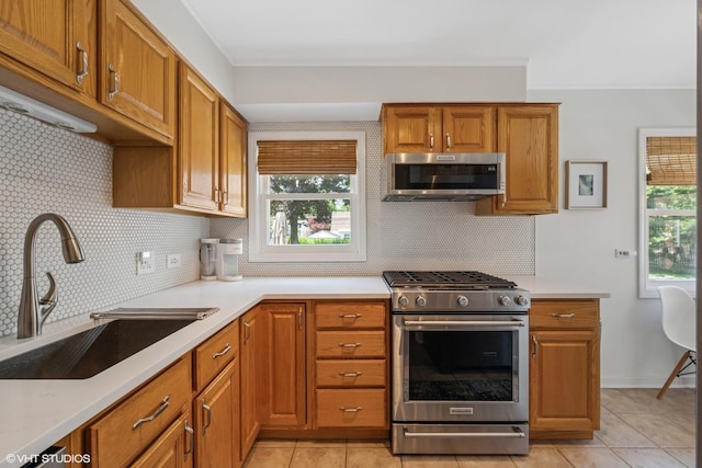 530 S Vail Ave, Arlington Heights, IL 60005 - kitchen with stainless steel appliances, brown cabinetry, light countertops, decorative backsplash, and ornamental molding