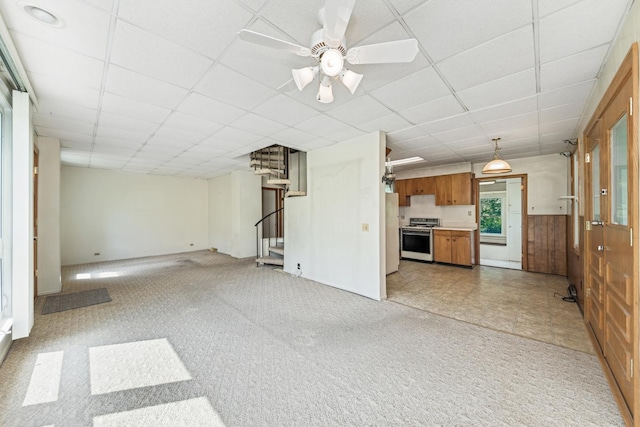 456 Grove St, Wood Dale, IL 60191 - unfurnished living room with light carpet, stairs, a drop ceiling, and ceiling fan