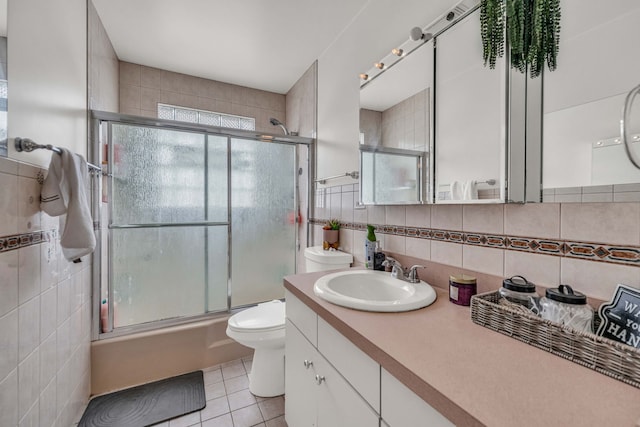 9113 Sycamore Dr, Hickory Hills, IL 60457 - bathroom featuring tile walls, vanity, tile patterned floors, combined bath / shower with glass door, and tasteful backsplash