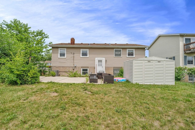 9113 Sycamore Dr, Hickory Hills, IL 60457 - back of house with a chimney, a storage shed, a lawn, and a patio