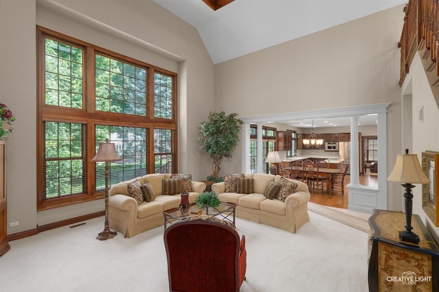 1105 Thoroughbred Cir, Saint Charles, IL 60174 - living room with high vaulted ceiling, a chandelier, and ornate columns