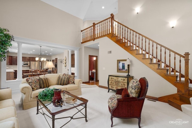 1105 Thoroughbred Cir, Saint Charles, IL 60174 - living area featuring a towering ceiling, a chandelier, stairway, ornate columns, and light colored carpet