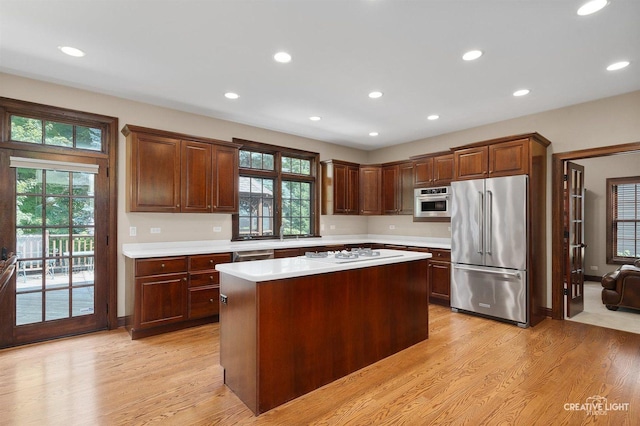 1105 Thoroughbred Cir, Saint Charles, IL 60174 - kitchen featuring high end refrigerator, light countertops, light wood-style floors, recessed lighting, and a center island