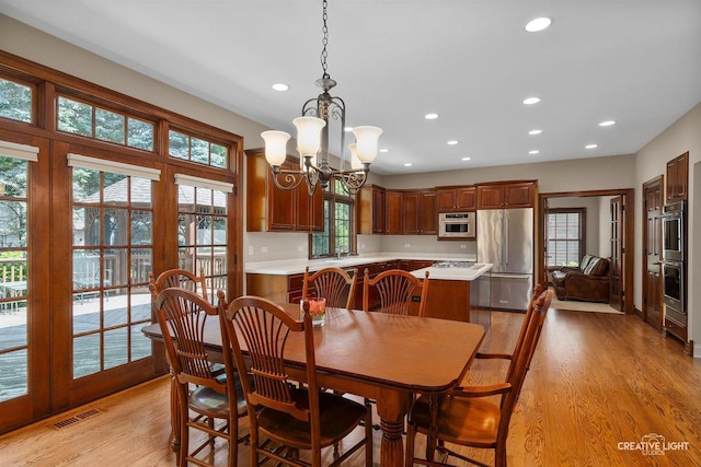 1105 Thoroughbred Cir, Saint Charles, IL 60174 - dining area with recessed lighting, light wood finished floors, and a chandelier