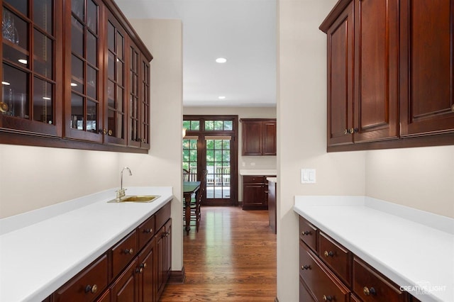 1105 Thoroughbred Cir, Saint Charles, IL 60174 - kitchen with light countertops, wood finished floors, recessed lighting, glass insert cabinets, and dark brown cabinetry