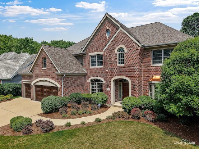 1105 Thoroughbred Cir, Saint Charles, IL 60174 - view of front of house with brick siding, a shingled roof, concrete driveway, and a garage
