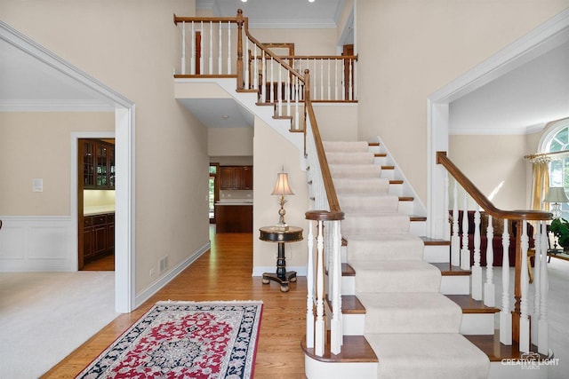 1105 Thoroughbred Cir, Saint Charles, IL 60174 - stairs featuring wood finished floors, ornamental molding, and a towering ceiling