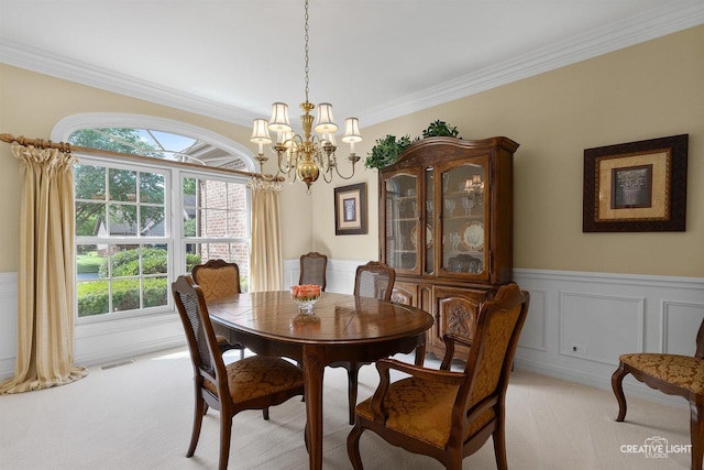 1105 Thoroughbred Cir, Saint Charles, IL 60174 - dining room with light colored carpet, a chandelier, a wainscoted wall, ornamental molding, and a decorative wall
