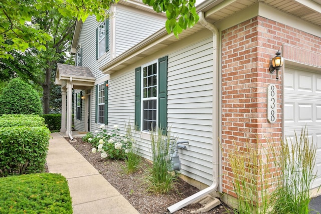 838 Stuarts Dr, Saint Charles, IL 60174 - view of side of home featuring an attached garage and brick siding