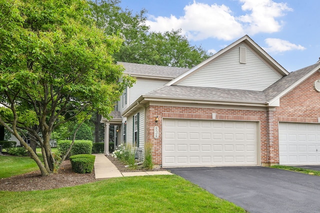 838 Stuarts Dr, Saint Charles, IL 60174 - traditional-style house with asphalt driveway, brick siding, a garage, and roof with shingles