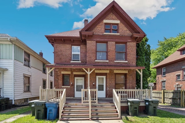 809 W 4th St, Sterling, IL 61081 - view of front of house with brick siding, covered porch, and a chimney