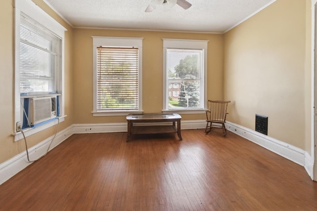 809 W 4th St, Sterling, IL 61081 - unfurnished room with wood-type flooring, ornamental molding, a ceiling fan, cooling unit, and a textured ceiling