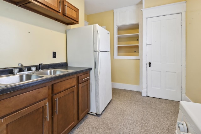 809 W 4th St, Sterling, IL 61081 - kitchen featuring freestanding refrigerator, brown cabinetry, and dark countertops