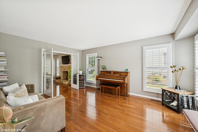 1460 Canter Ln, Bartlett, IL 60103 - living area with wood finished floors and a fireplace with raised hearth