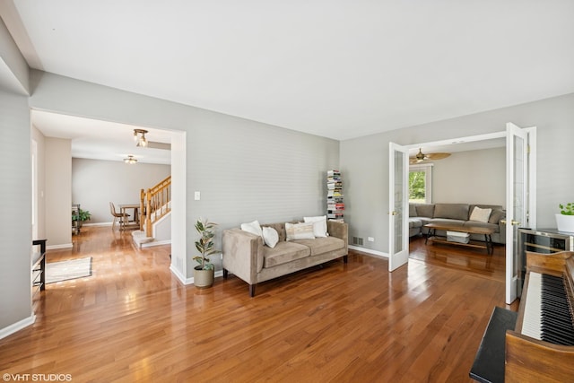 1460 Canter Ln, Bartlett, IL 60103 - living room featuring stairway, light wood finished floors, and a ceiling fan