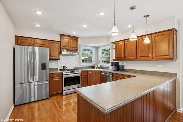1460 Canter Ln, Bartlett, IL 60103 - kitchen featuring appliances with stainless steel finishes, under cabinet range hood, brown cabinetry, a peninsula, and recessed lighting