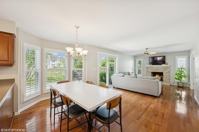 1460 Canter Ln, Bartlett, IL 60103 - dining area with hardwood / wood-style flooring, a stone fireplace, ceiling fan, and a chandelier