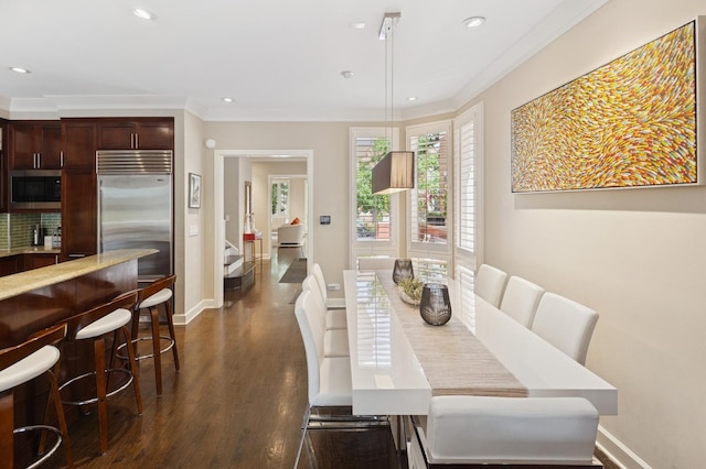 2446 N Janssen Ave, Chicago, IL 60614 - dining area with dark wood finished floors, ornamental molding, and recessed lighting