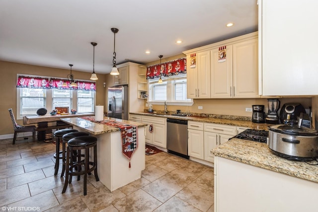 1325 Gunderson Ave, Berwyn, IL 60402 - kitchen with appliances with stainless steel finishes, plenty of natural light, a kitchen bar, a kitchen island, and recessed lighting