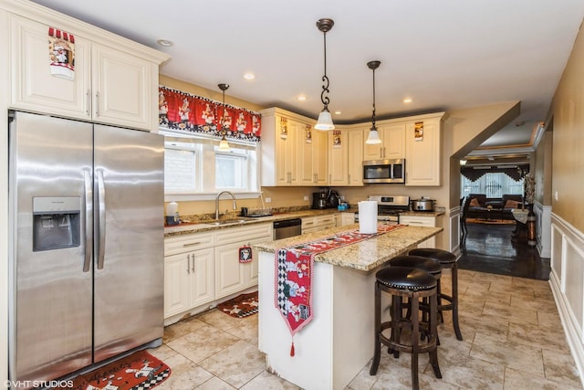 1325 Gunderson Ave, Berwyn, IL 60402 - kitchen with stainless steel appliances, light stone counters, pendant lighting, a center island, and recessed lighting