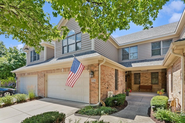 3716 King Charles Ln, Saint Charles, IL 60174 - view of front of house featuring brick siding, a garage, concrete driveway, and a porch