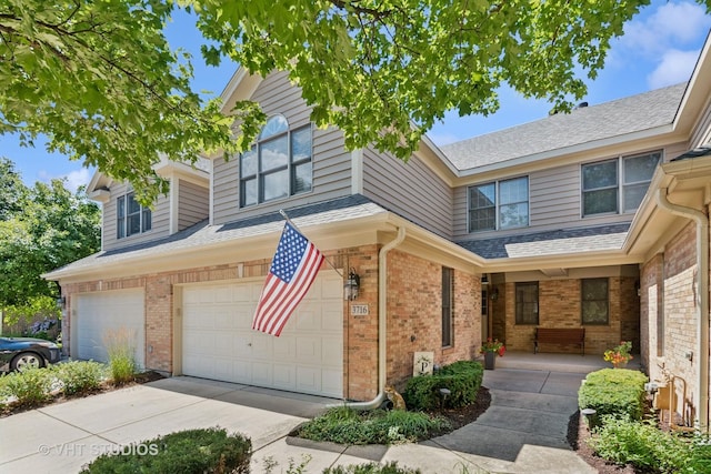 3716 King Charles Ln, Saint Charles, IL 60174 - view of front of home with brick siding, a garage, driveway, and covered porch