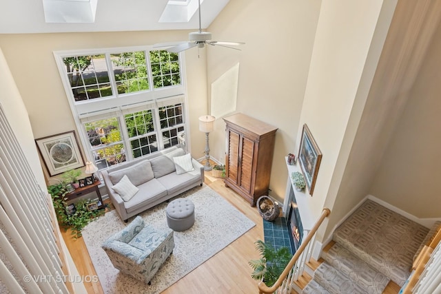 3716 King Charles Ln, Saint Charles, IL 60174 - living room featuring a skylight, a high ceiling, wood finished floors, and ceiling fan