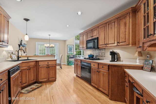 3716 King Charles Ln, Saint Charles, IL 60174 - kitchen featuring black appliances, brown cabinets, light wood-style floors, a chandelier, and recessed lighting