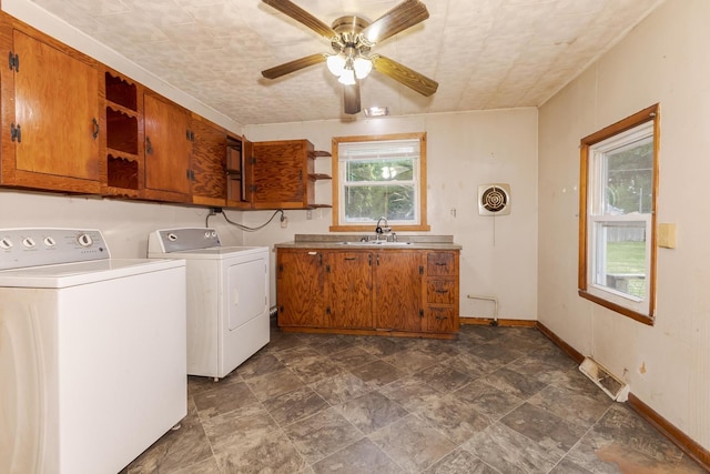 607 W Grant Ave, Pontiac, IL 61764 - laundry room featuring cabinet space, washing machine and dryer, a ceiling fan, and stone finish flooring