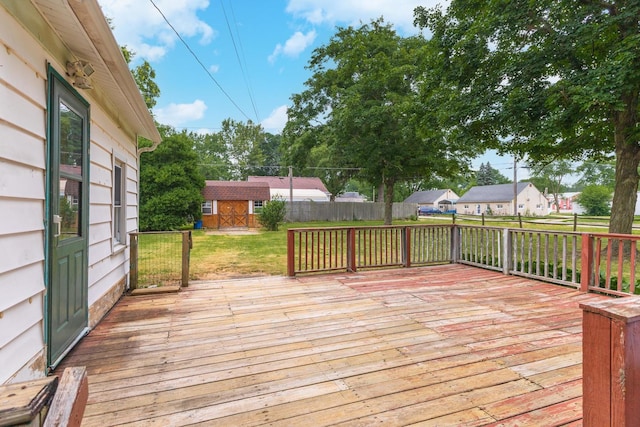 607 W Grant Ave, Pontiac, IL 61764 - wooden deck featuring a fenced backyard, an outdoor structure, and a residential view
