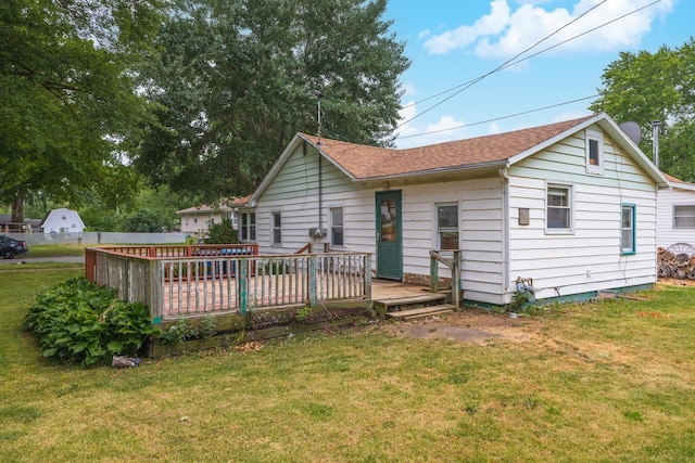607 W Grant Ave, Pontiac, IL 61764 - back of house with a deck, a lawn, and roof with shingles