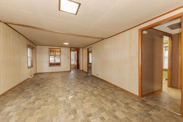 607 W Grant Ave, Pontiac, IL 61764 - spare room featuring baseboards and wood walls
