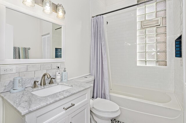 4738 S Champlain Ave, Chicago, IL 60615 - bathroom featuring vanity, shower / bath combo with shower curtain, and plenty of natural light