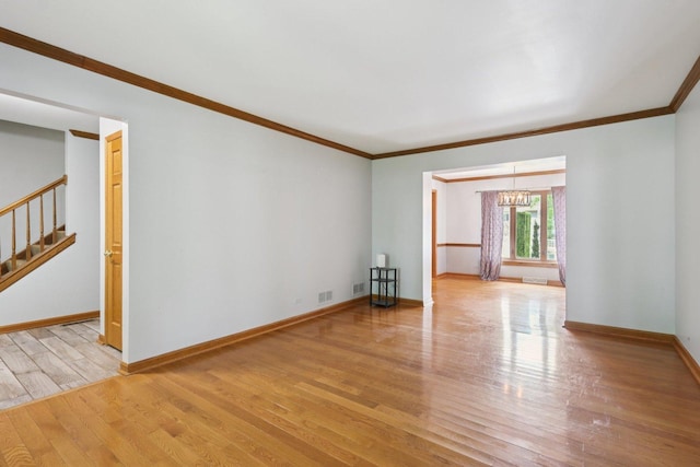 584 Beaconsfield Ave, Naperville, IL 60565 - unfurnished room with wood finished floors, stairway, ornamental molding, and a chandelier